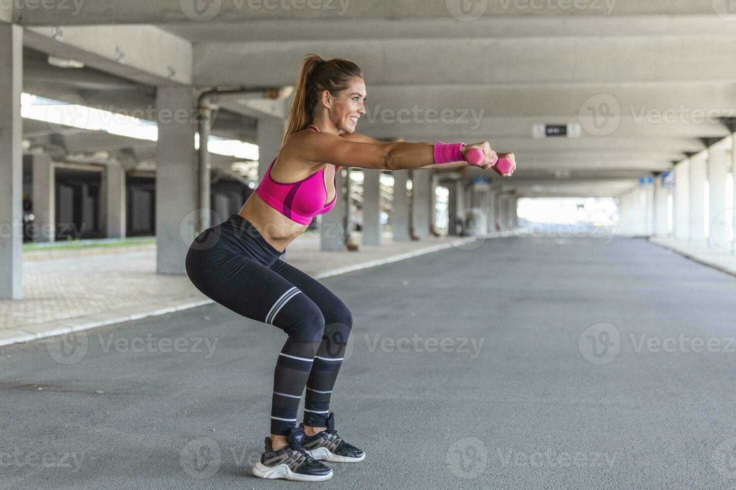 Sporty woman exercising with dumbbells. Photo of active woman in sportswear working out. Dynamic movement. Side view. Sport and healthy lifestyle