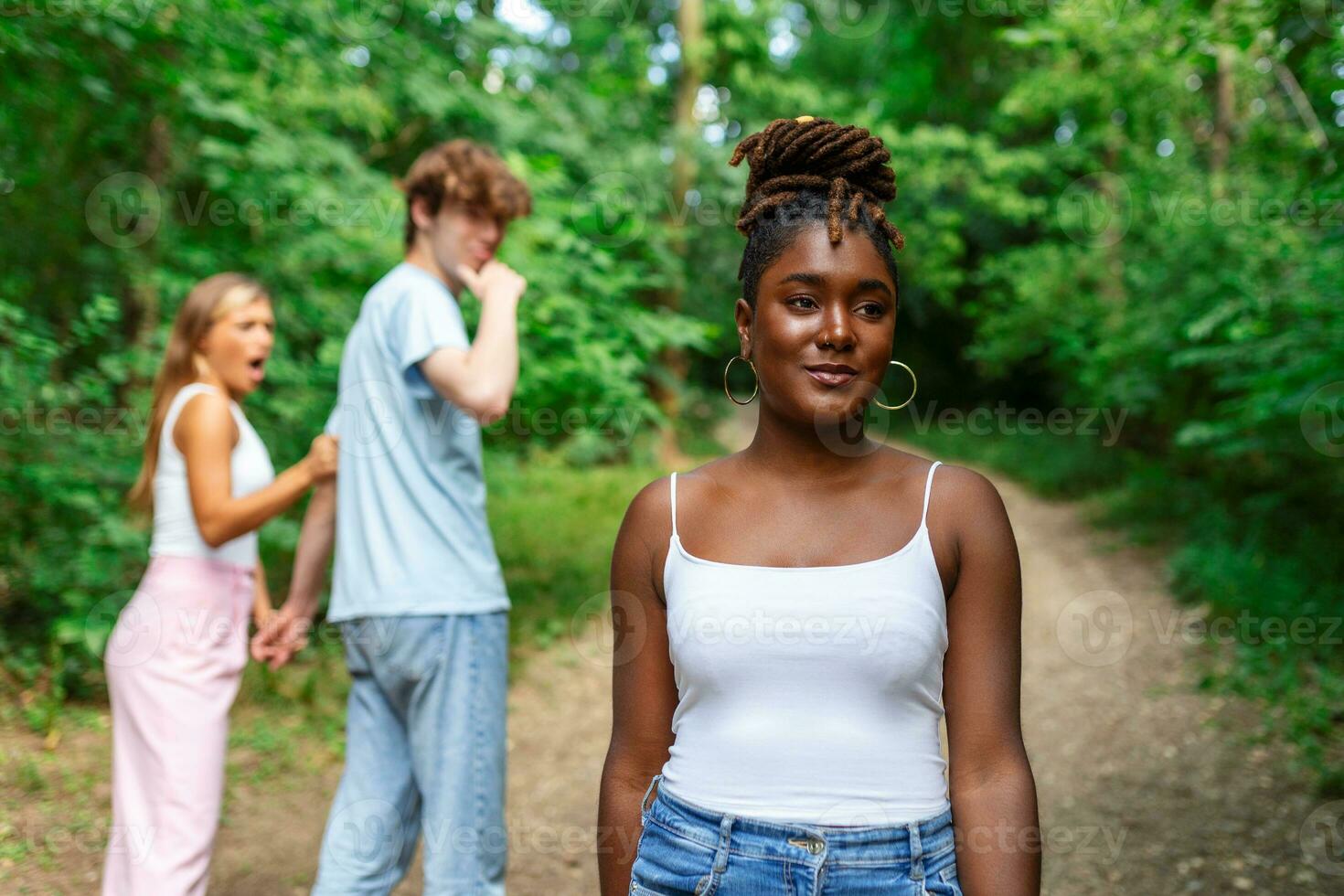 Disloyal man walking with his girlfriend and looking amazed at another seductive girl photo