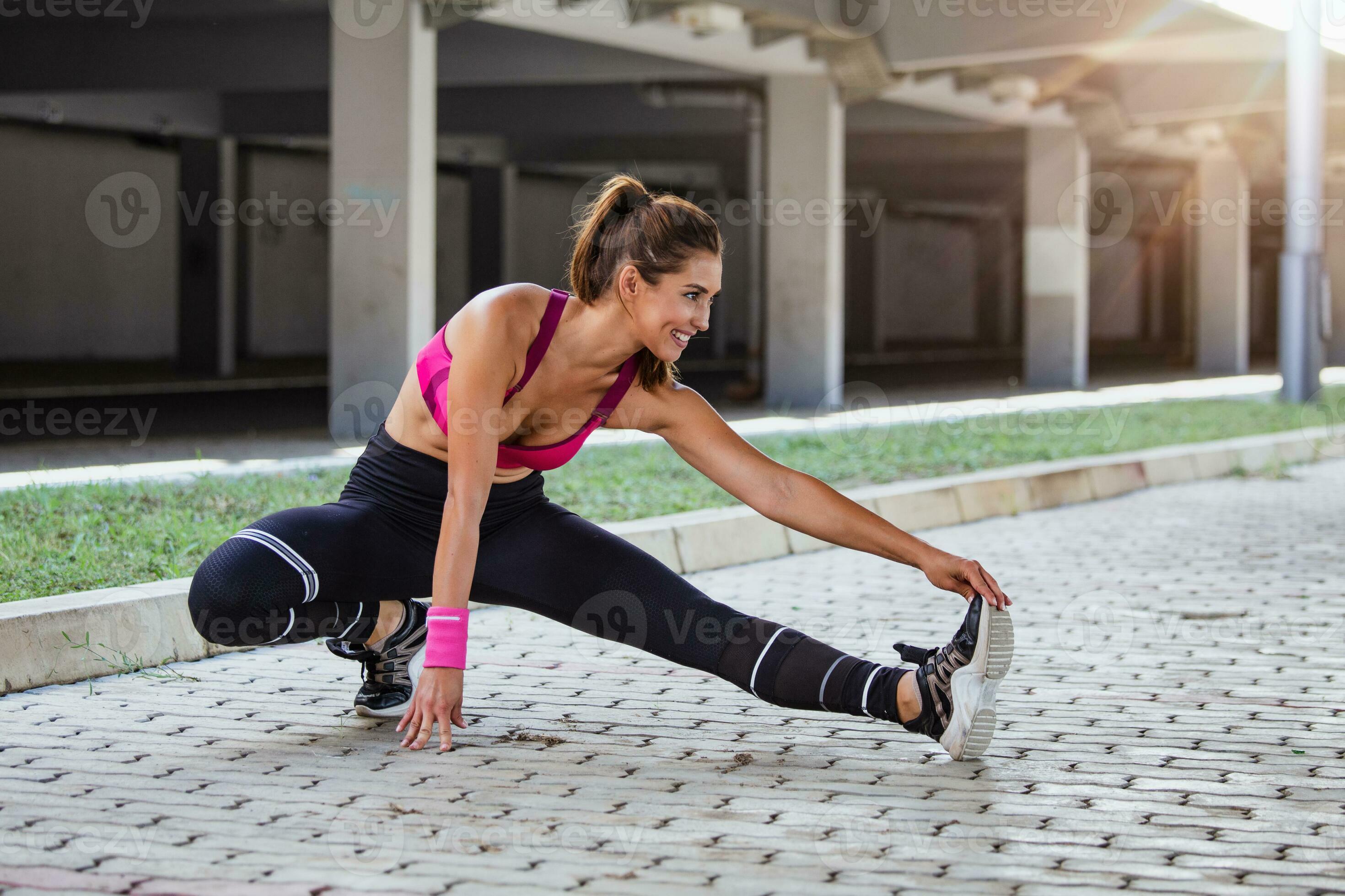 Healthy sports lifestyle. Athletic young woman in sports dress doing  fitness exercise. Fitness woman stretching legs before run 23748602 Stock  Photo at Vecteezy