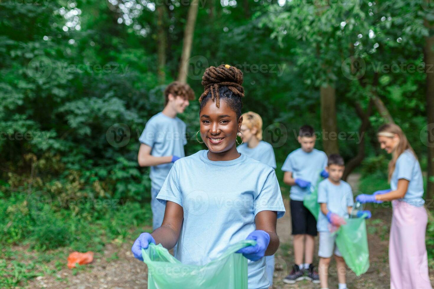 Volunteers collecting garbage from park, environmental awareness is important to save our planet photo