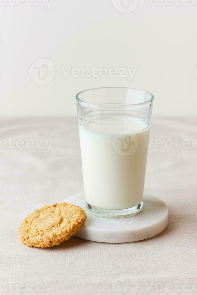 Glass of fresh milk with oatmeal cookie photo