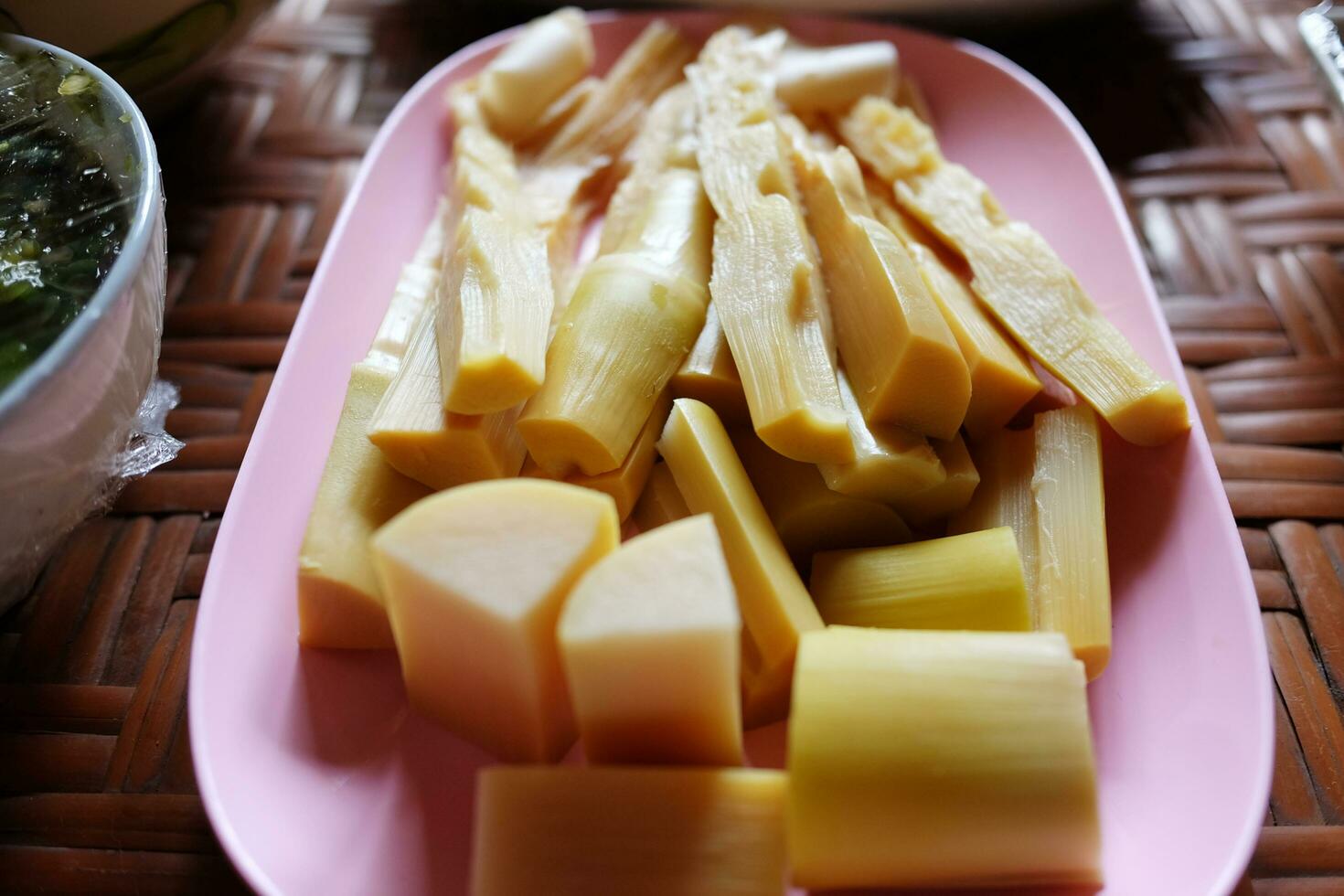Boiled bamboo shoots on pink dish for vegetable eaten with chili paste or pepper sauce is tradition Thai food photo