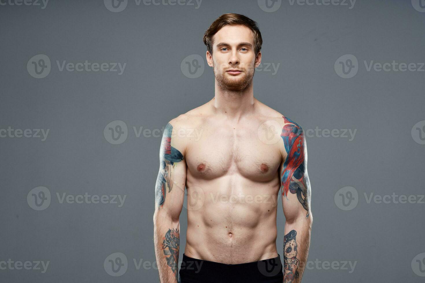 pumped up nude torso men tattoos close-up exercise photo