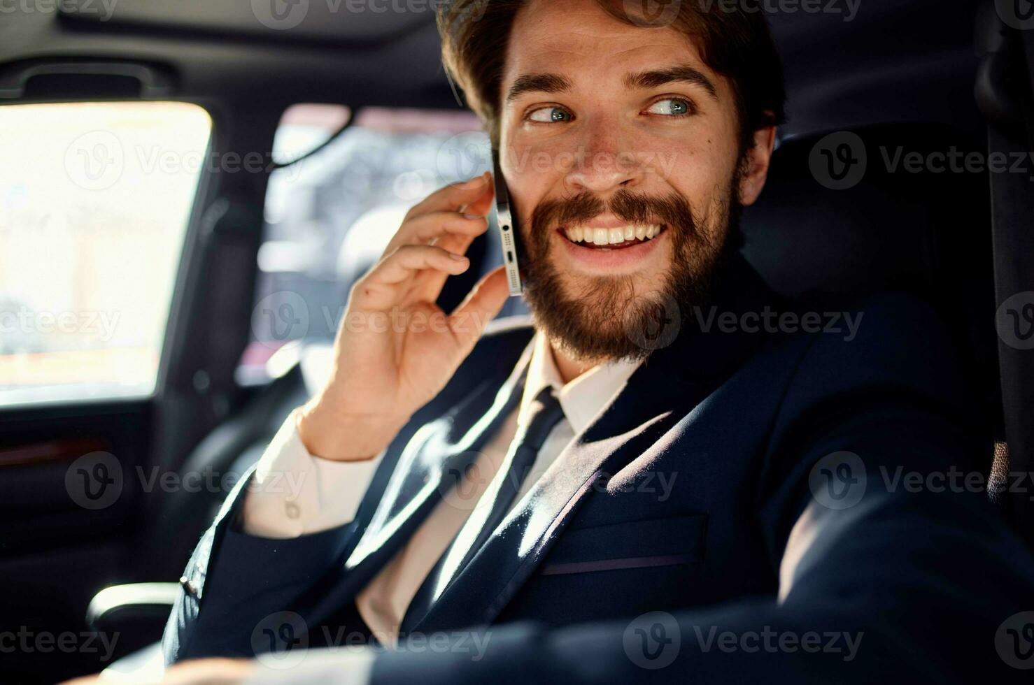 bearded man Driving a car trip luxury lifestyle success service rich photo