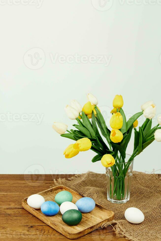 bouquet of flowers in a vase colorful eggs easter holiday photo