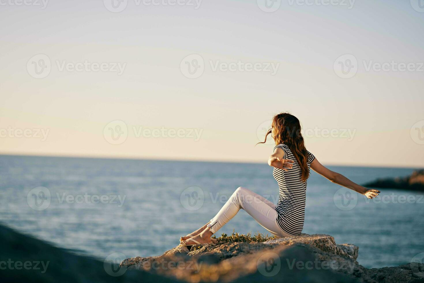 Woman outdoors landscape mountains sun sea photo