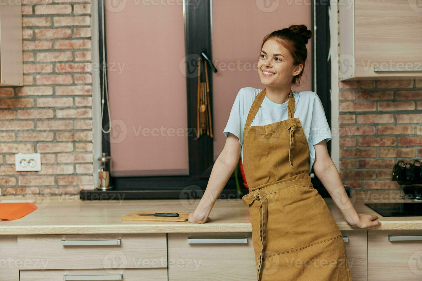 woman in an apron in the kitchen housework Lifestyle photo
