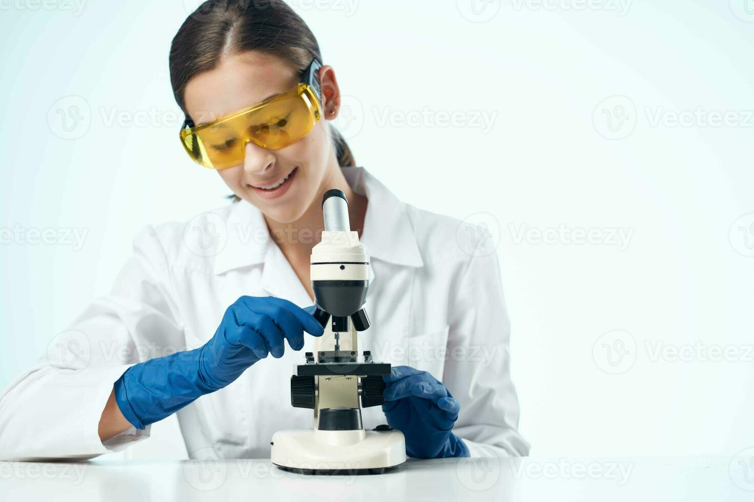 woman with microscope in laboratory research scientists photo