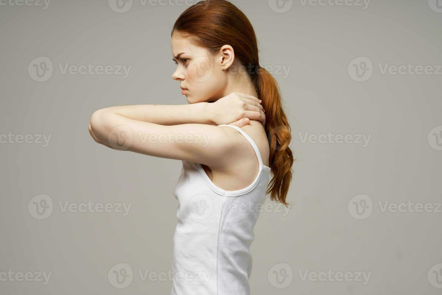 woman holding on to the neck health problems joint studio treatment photo