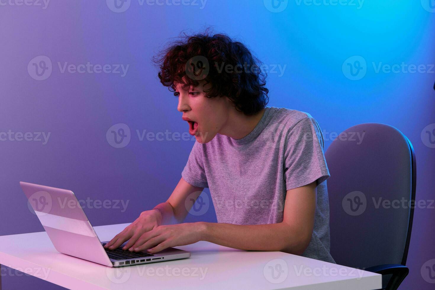 curly guy in front of laptop entertainment Lifestyle technology photo