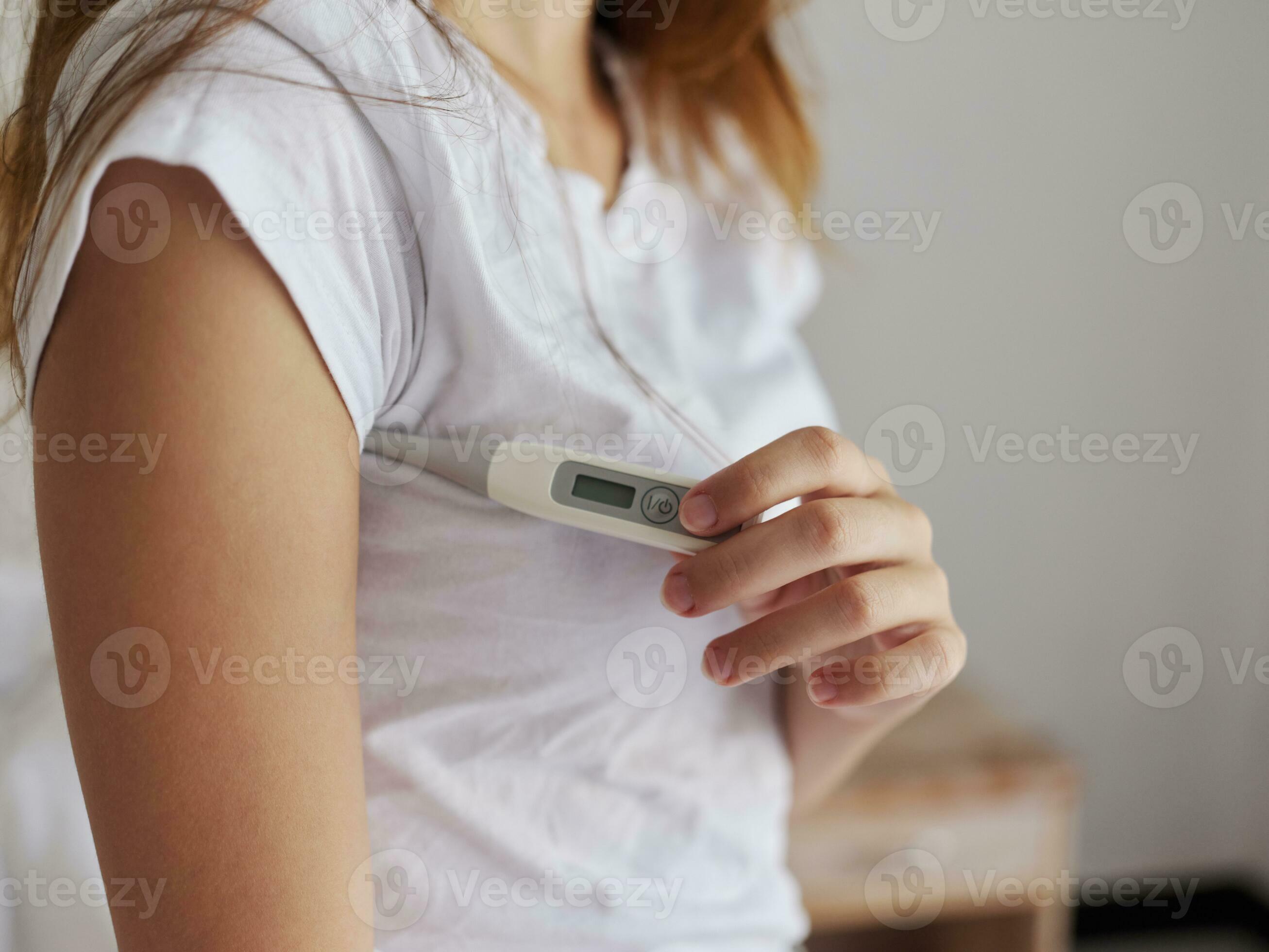 woman in white tshirt hold thermometer armpit temperature 23756419 Stock Photo at Vecteezy