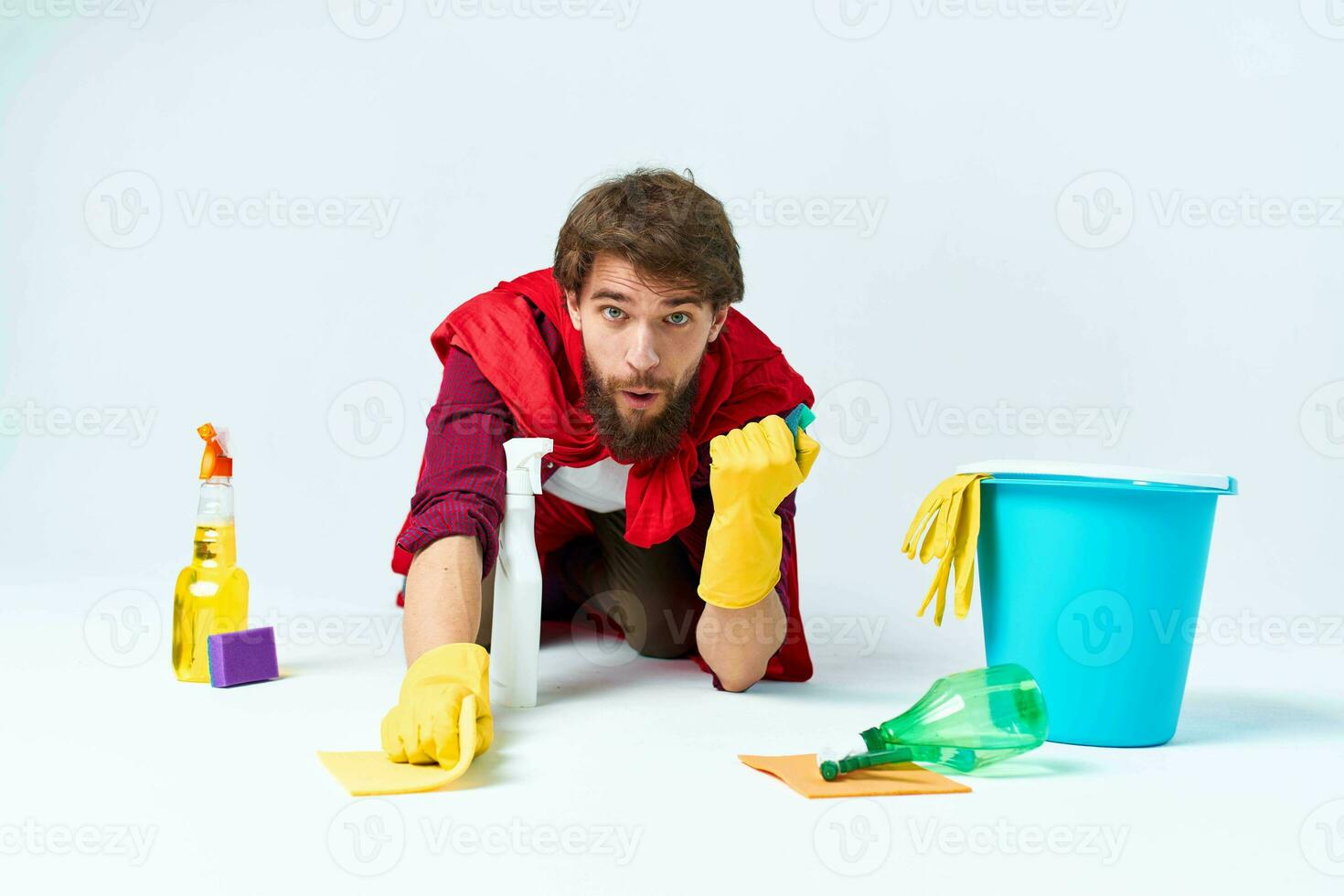 Man on the floor cleaning the house cleaning supplies Professional photo