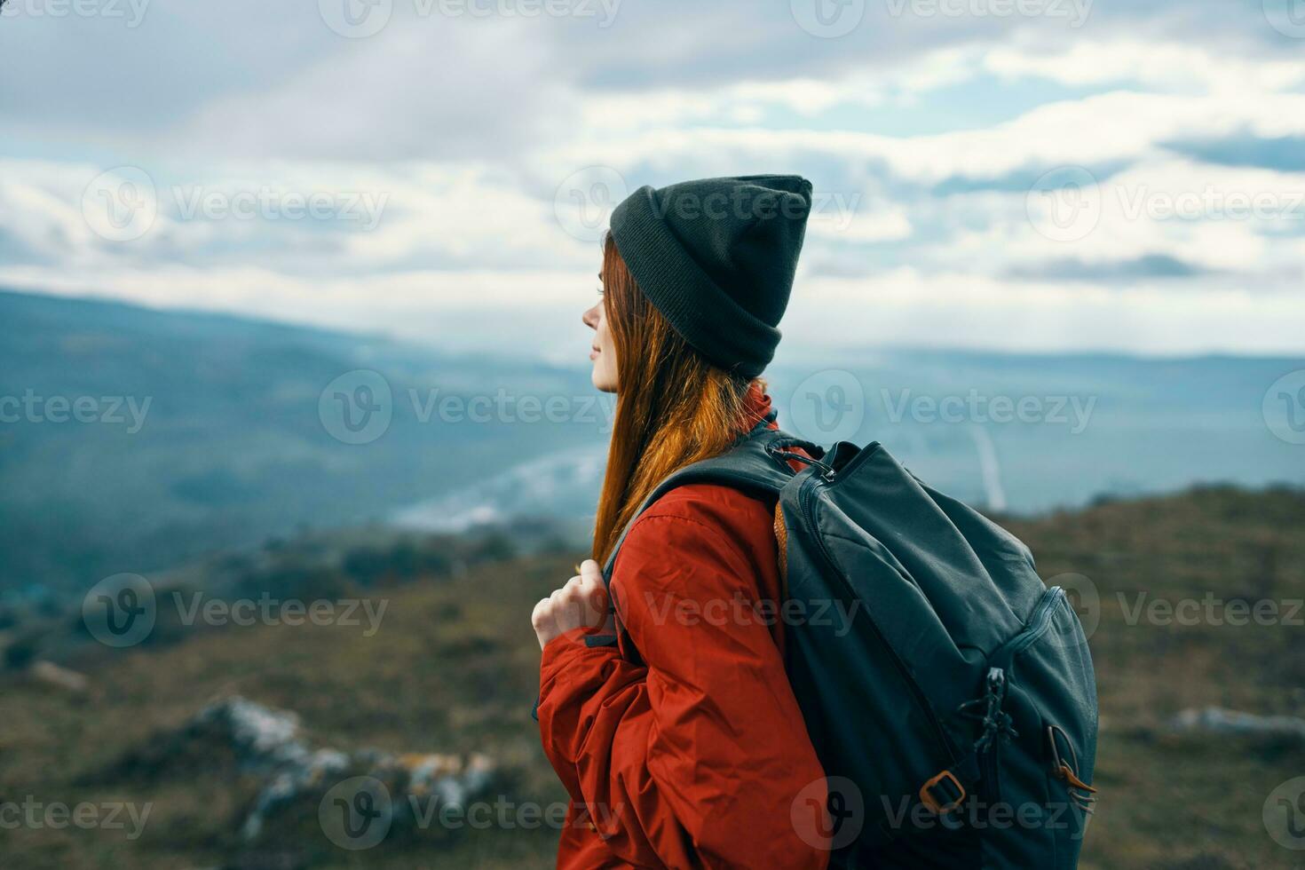 woman jacket hats looking at the mountain in the distance blue sky clouds Model backpack photo
