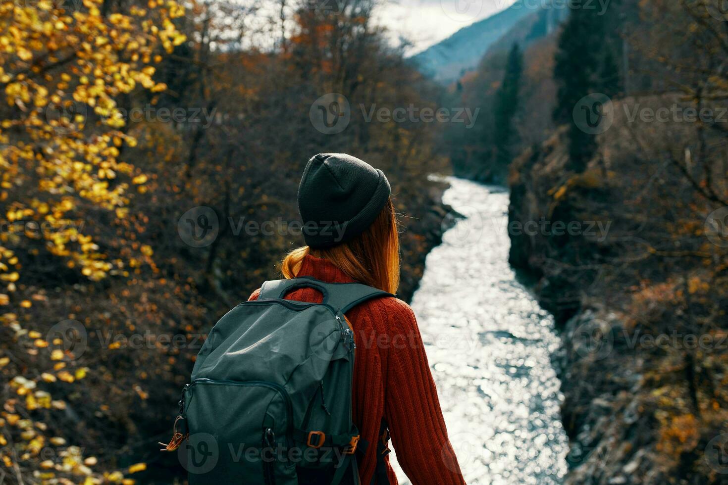 woman with backpack on her back river mountains nature travel photo