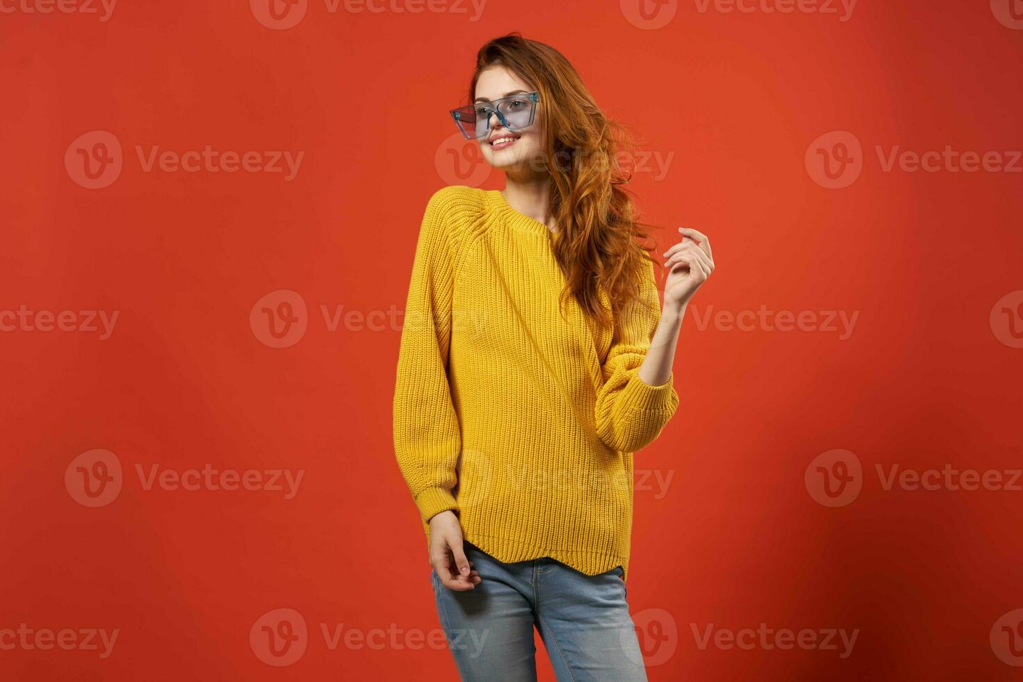 cheerful woman in yellow sweater blue glasses posing studio photo