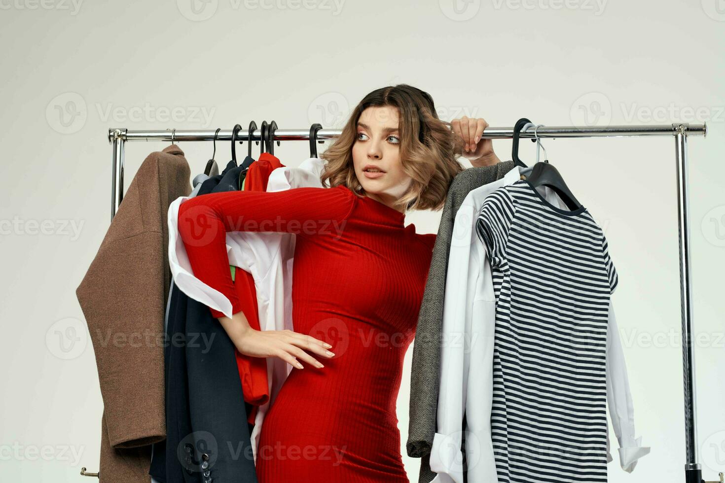 beautiful woman trying on clothes shop shopaholic light background photo