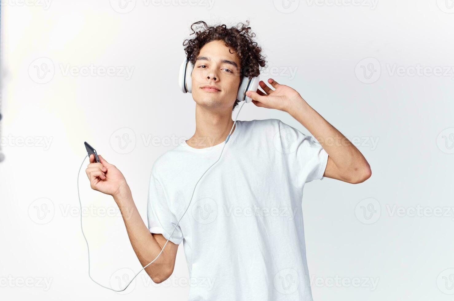 Cheerful man in headphones listens to music technology dancing photo