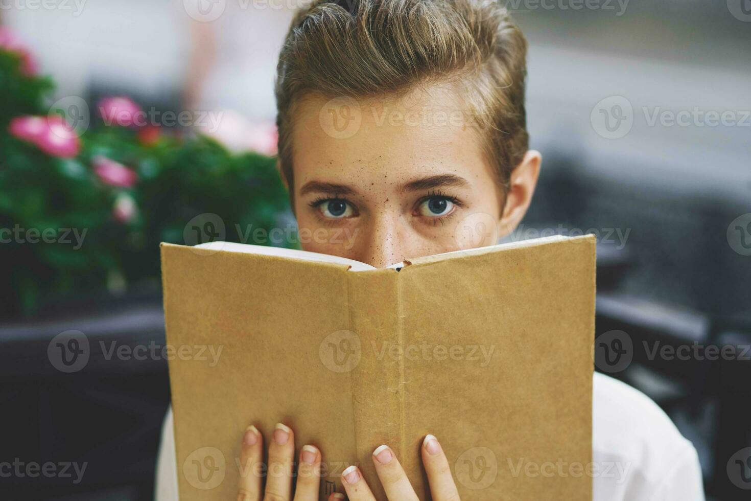 student with a book in his hands reading walk in the fresh air education photo