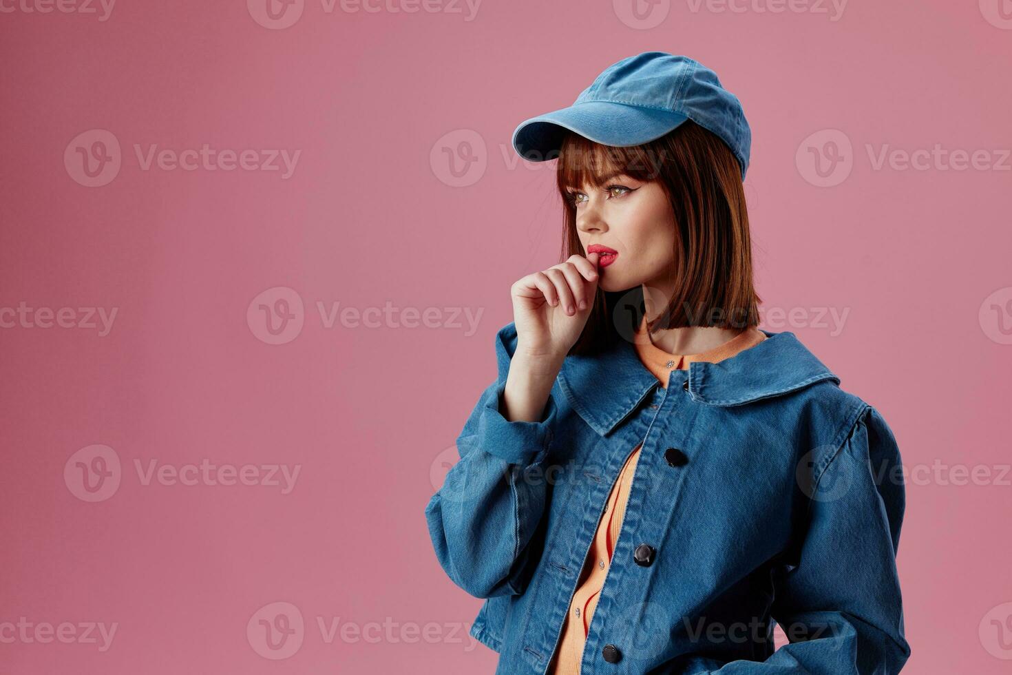 Portrait of a charming lady denim clothing fashion posing cap studio model unaltered photo