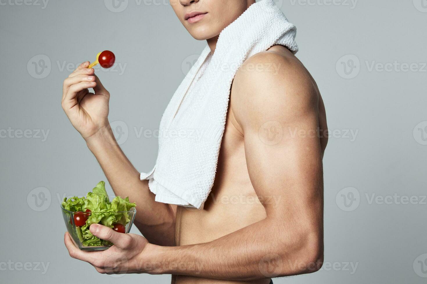 athletic man bodybuilder healthy eating plate salad close-up photo