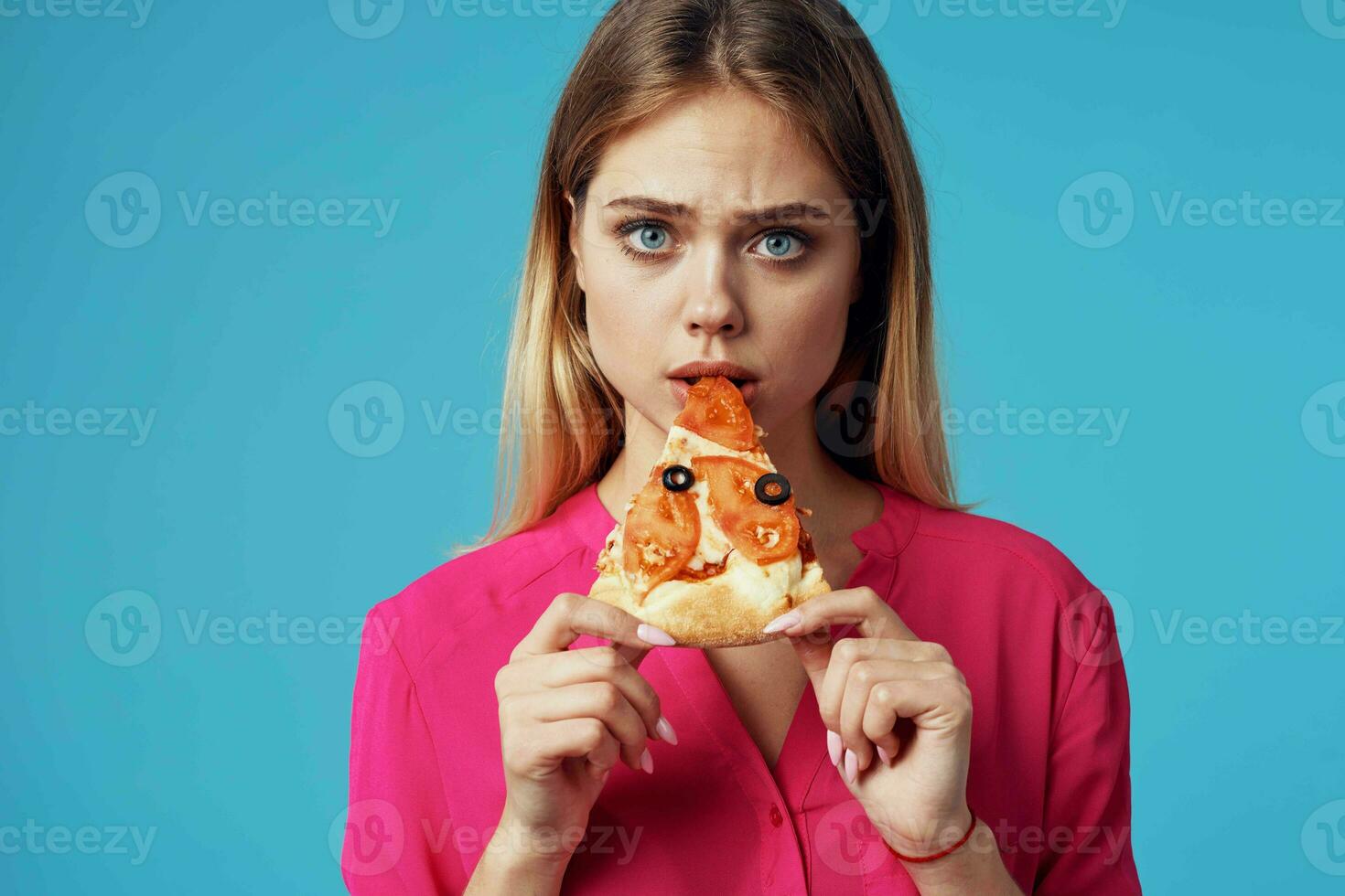 woman in a pink shirt with pizza in her hands junk food close-up photo