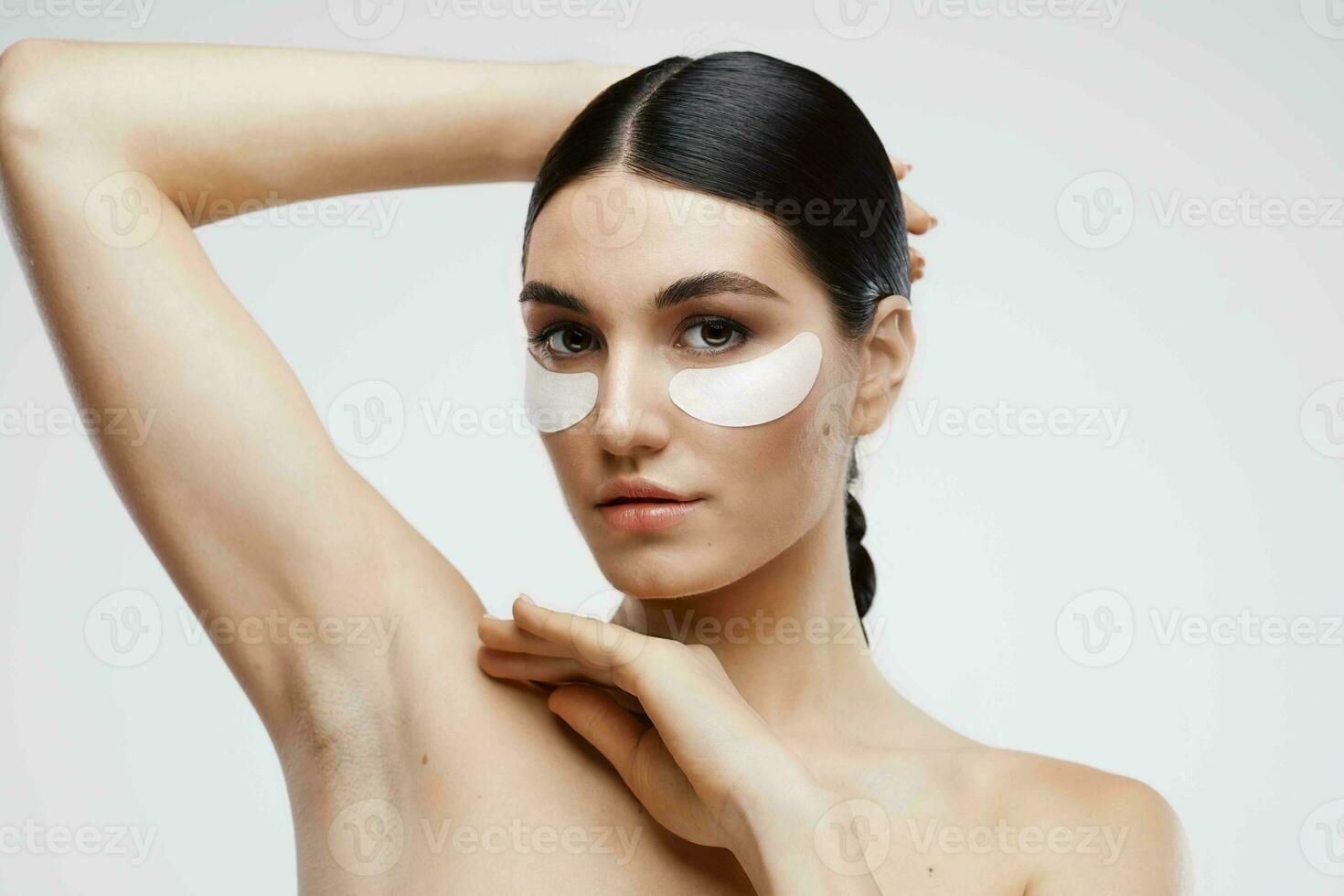 woman with bare shoulders patches near eyes cosmetics photo