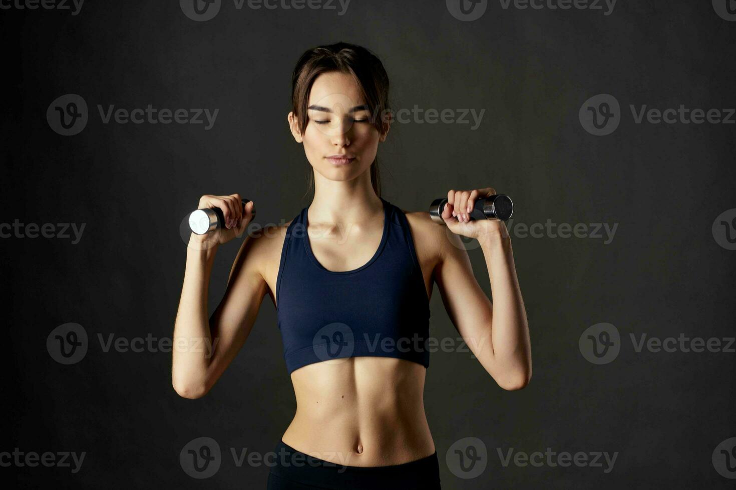 woman in sports uniform with dumbbells workout motivation fitness photo