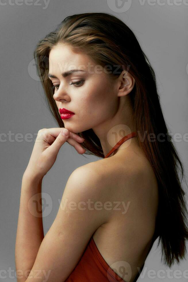 Woman with red lipstick looks down makeup glamor cropped view close-up photo