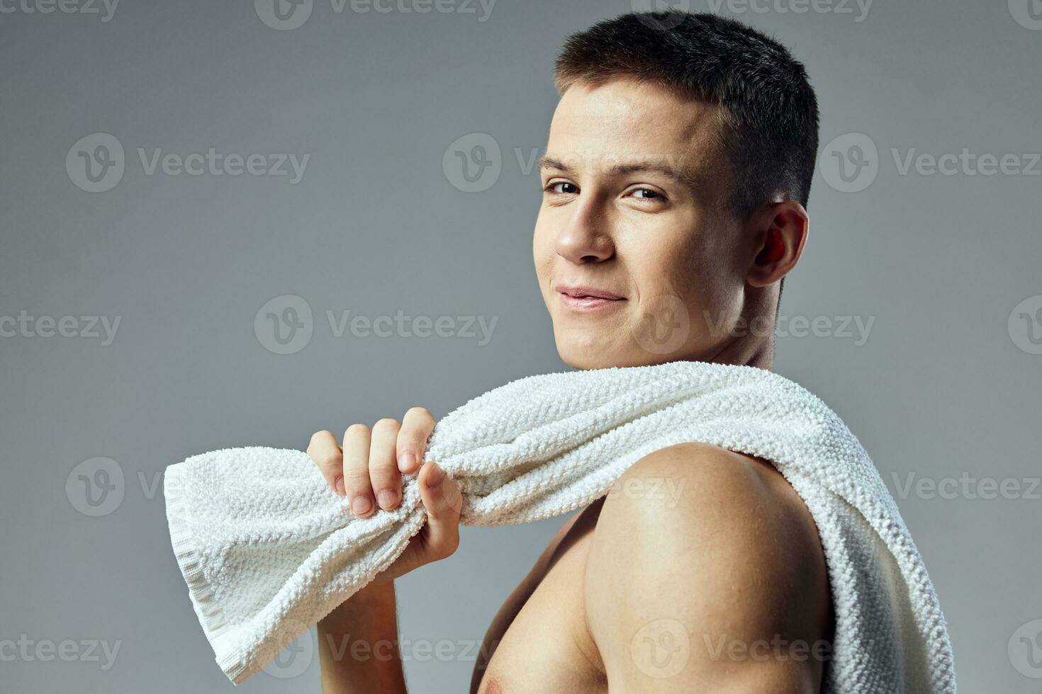 cute guy with a towel on his shoulders smile close-up workout photo