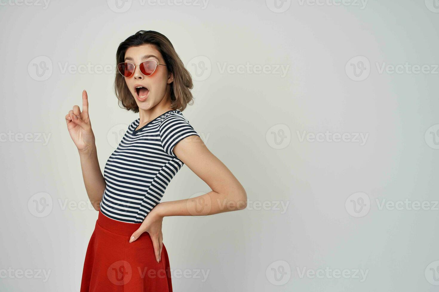 cheerful woman in sunglasses striped t-shirt red skirt photo