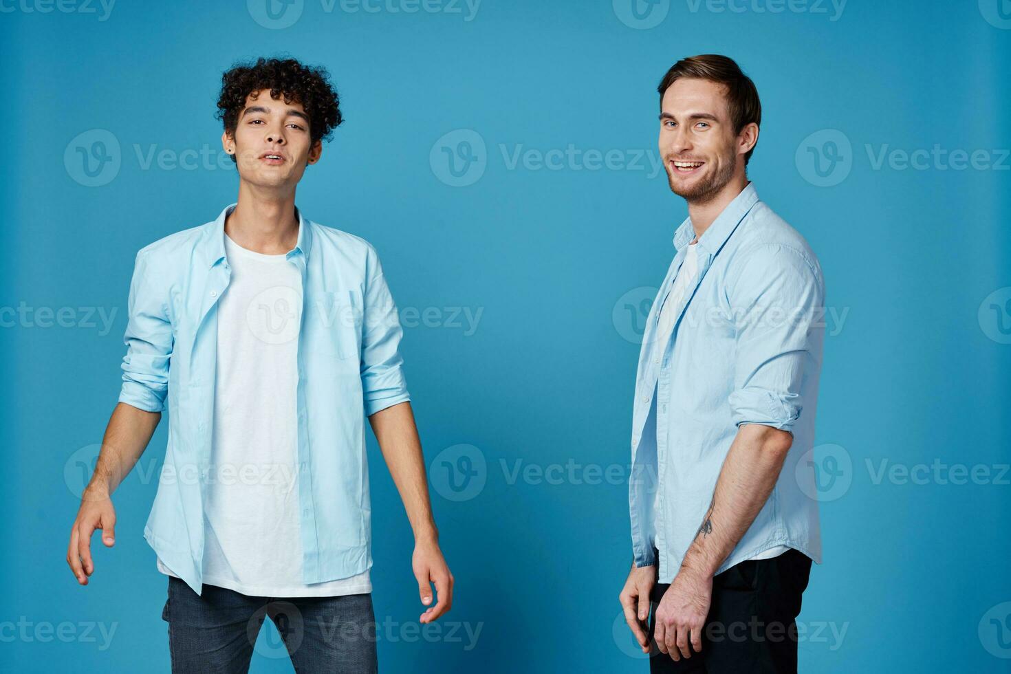 young guys in matching t-shirts and shirts fun greetings blue background friends photo