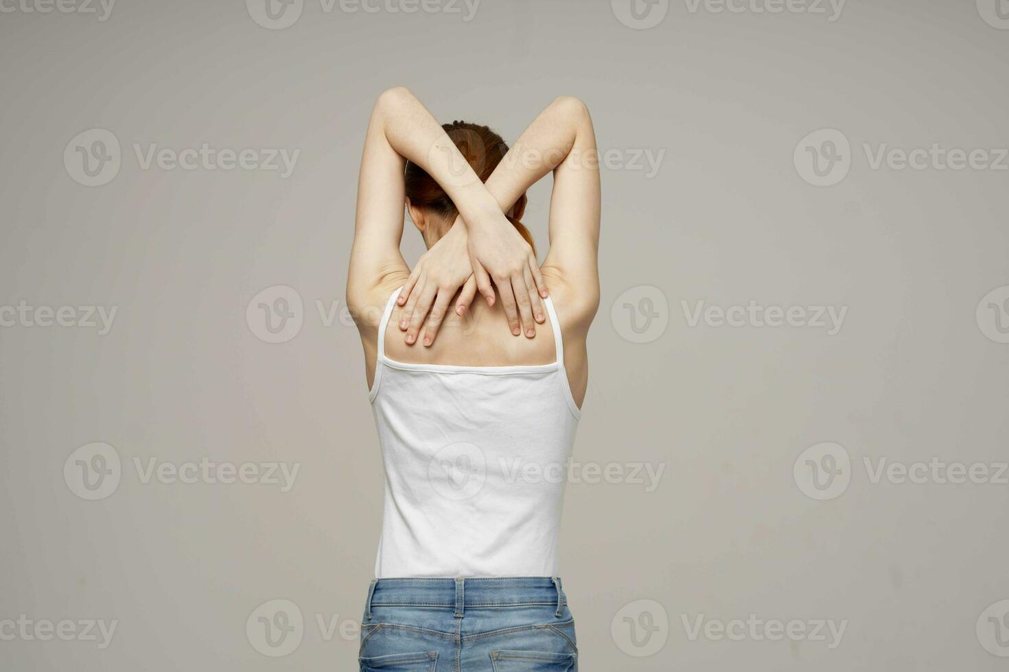 disgruntled woman back pain health problems osteoporosis light background photo