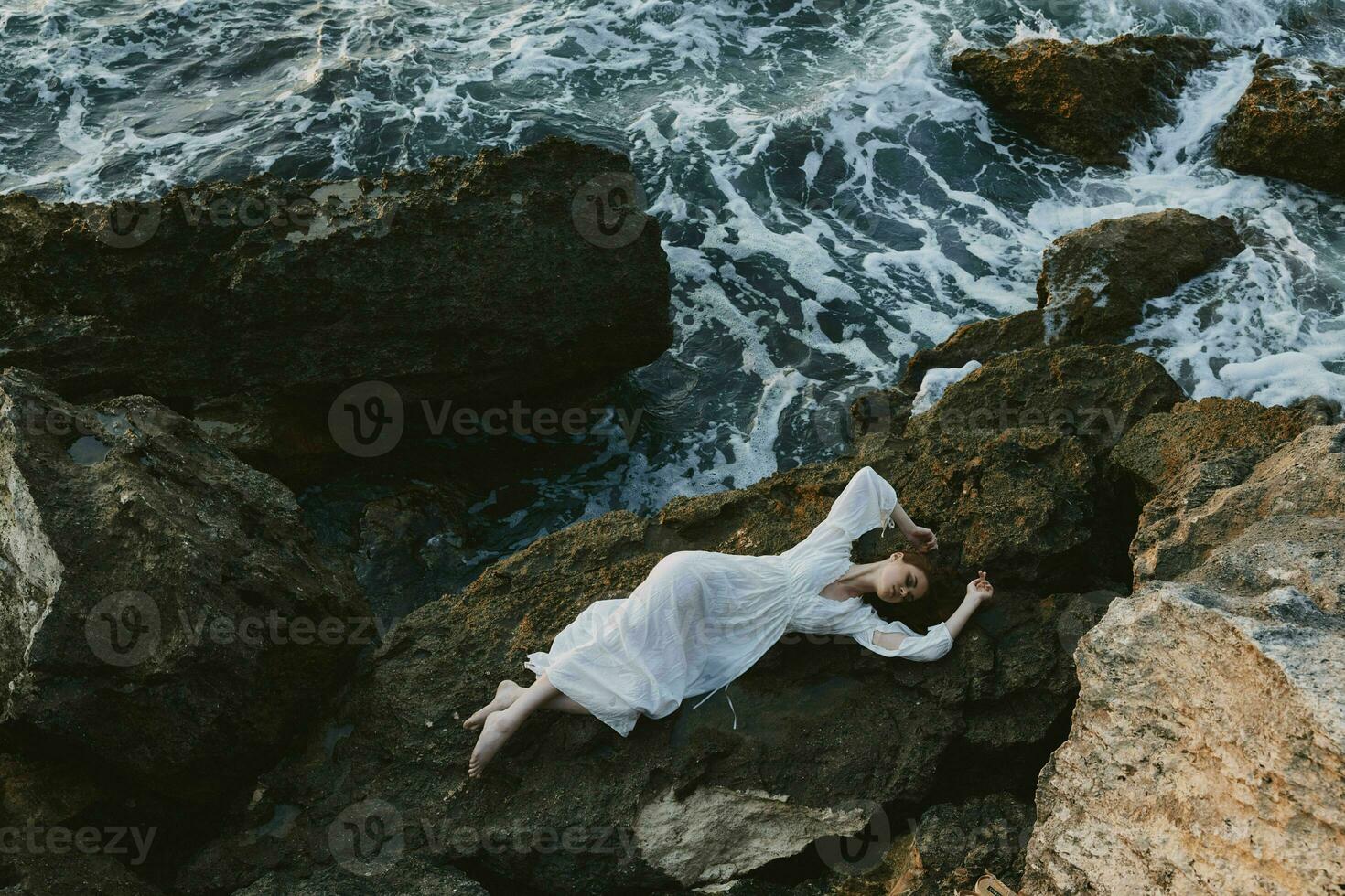 Beautiful bride in white wedding dress on sea shore wet hair unaltered photo