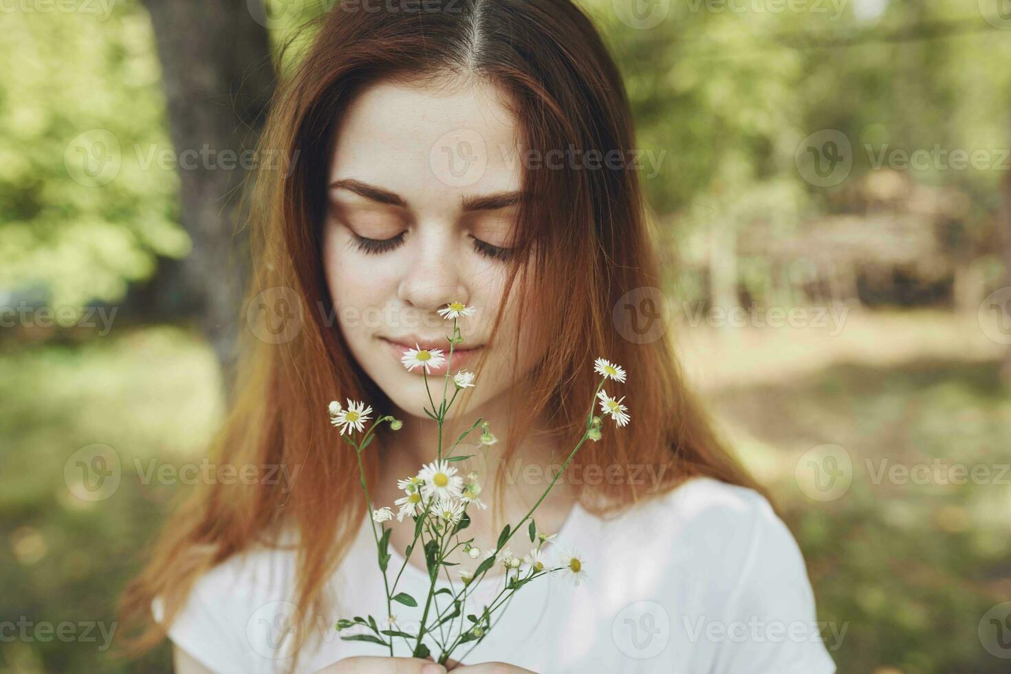 red-haired woman with bouquet of flowers nature trees summer vacation photo