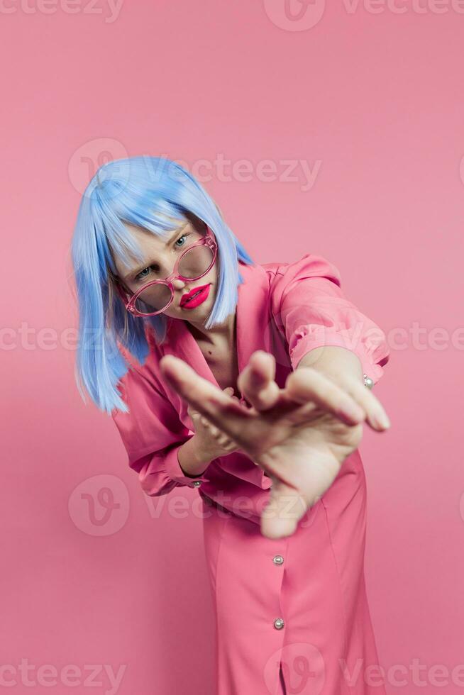 portrait of a woman in blue wig pink dress red lips isolated background photo