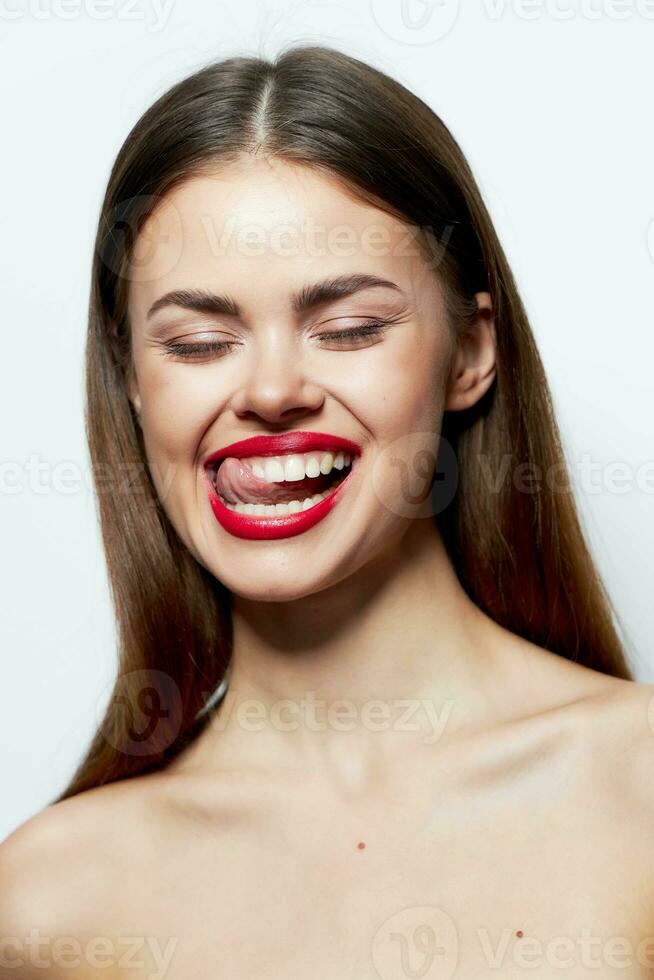 Woman Bare shoulders closed eyes showing tongue natural look light photo