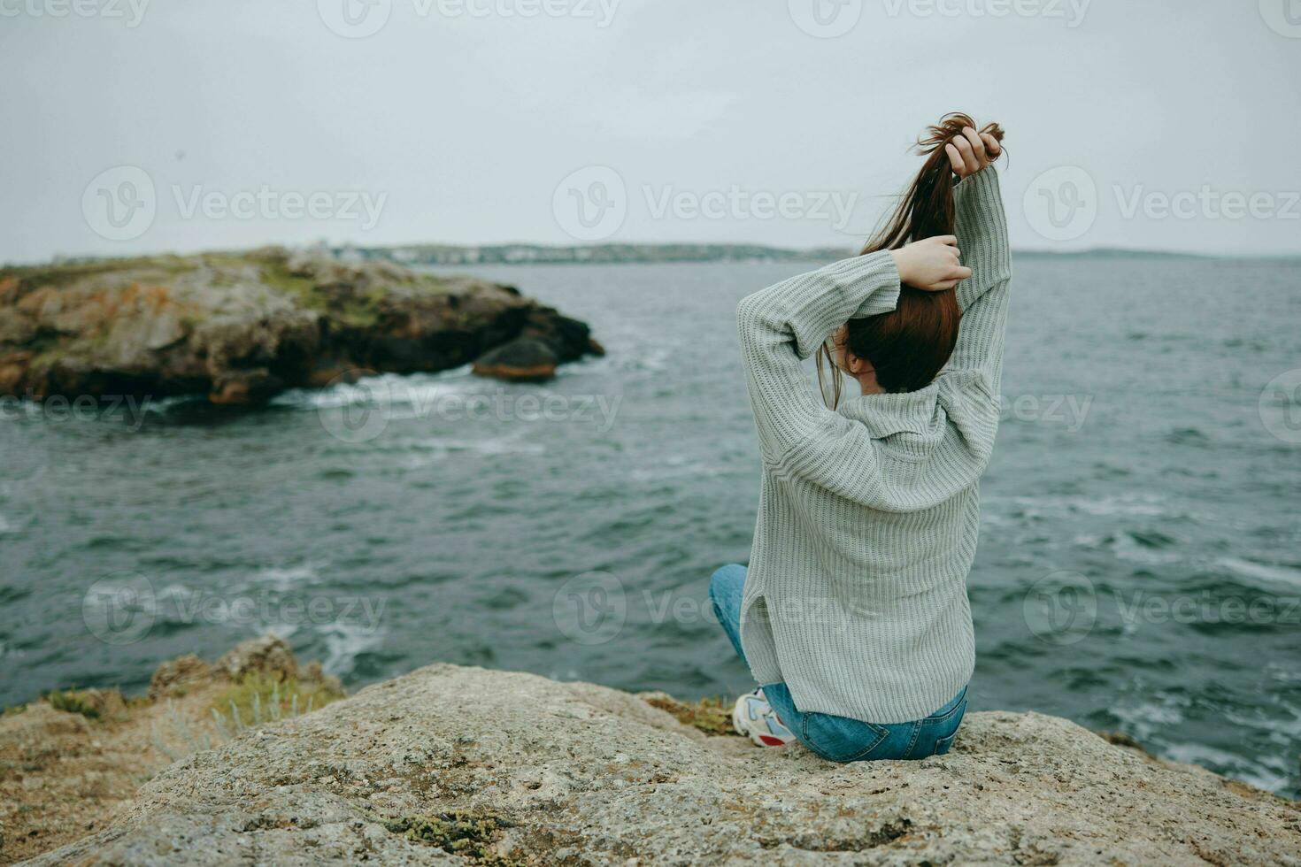 pretty woman long hair nature rocks coast landscape female relaxing photo