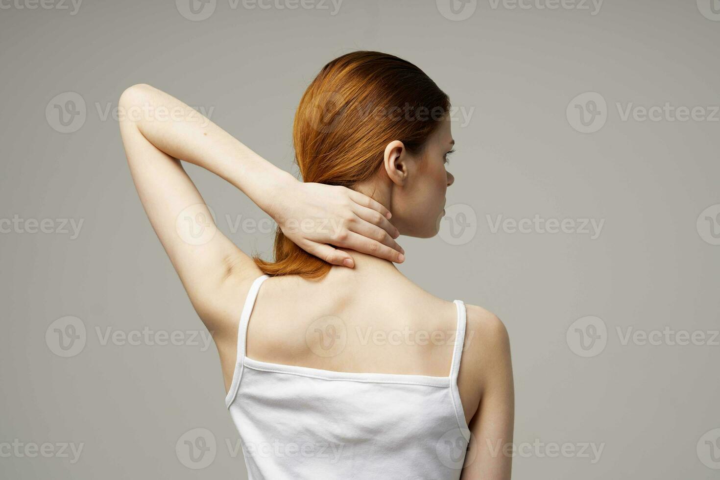 woman in white t-shirt pain in the neck arthritis chronic disease studio treatment photo