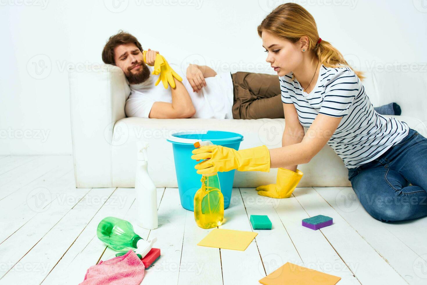 young couple at home near sofa washing supplies cleaning lifestyle photo