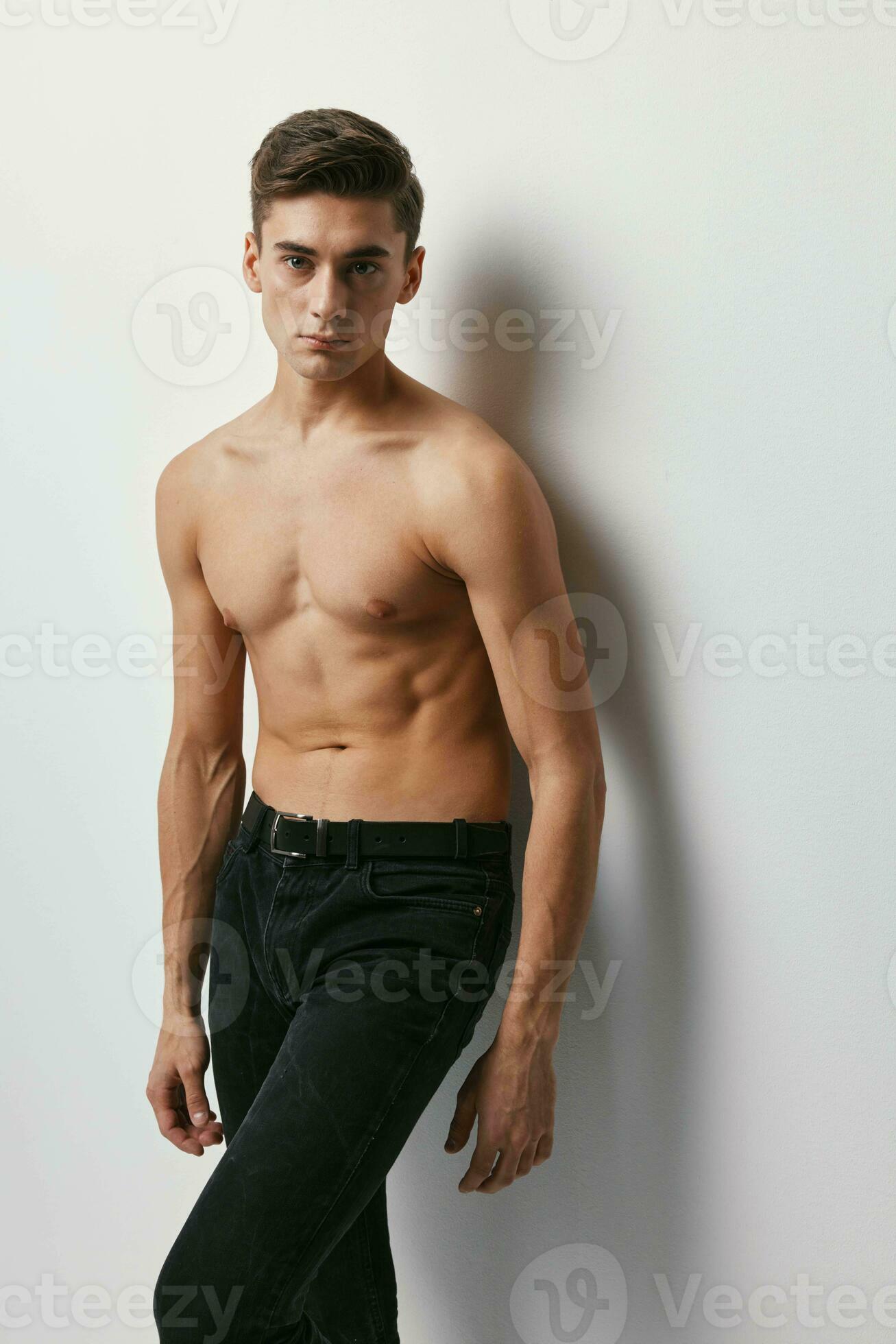 Handsome guy nude torso black pants light background 23762480 Stock