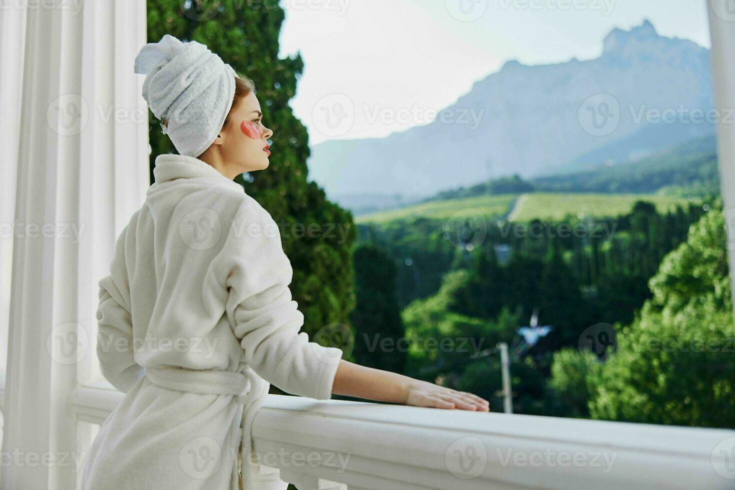 Portrait woman stands on the balcony of the hotel unaltered photo