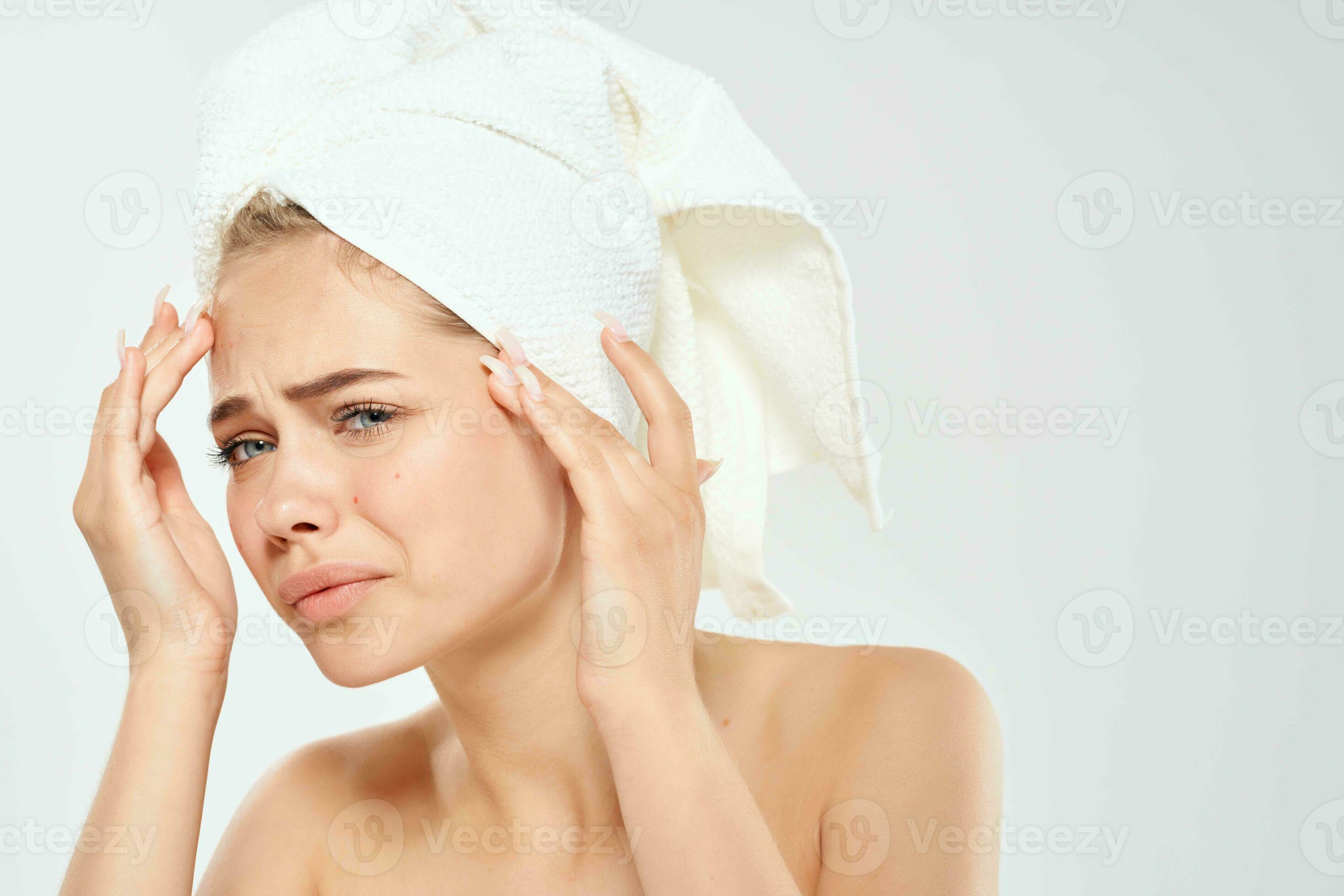 woman with towel on head acne dermatology dissatisfaction skin problems