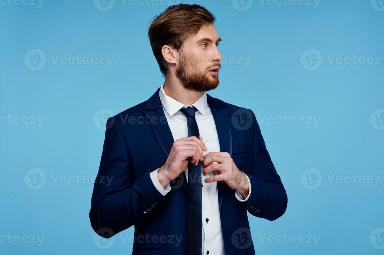 man in a suit straightens his tie self confidence fashion businessman photo
