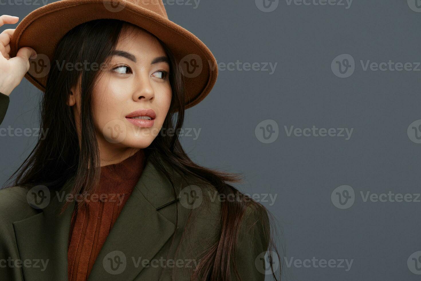 beautiful woman in a stylish suit beige hat posing studio model photo