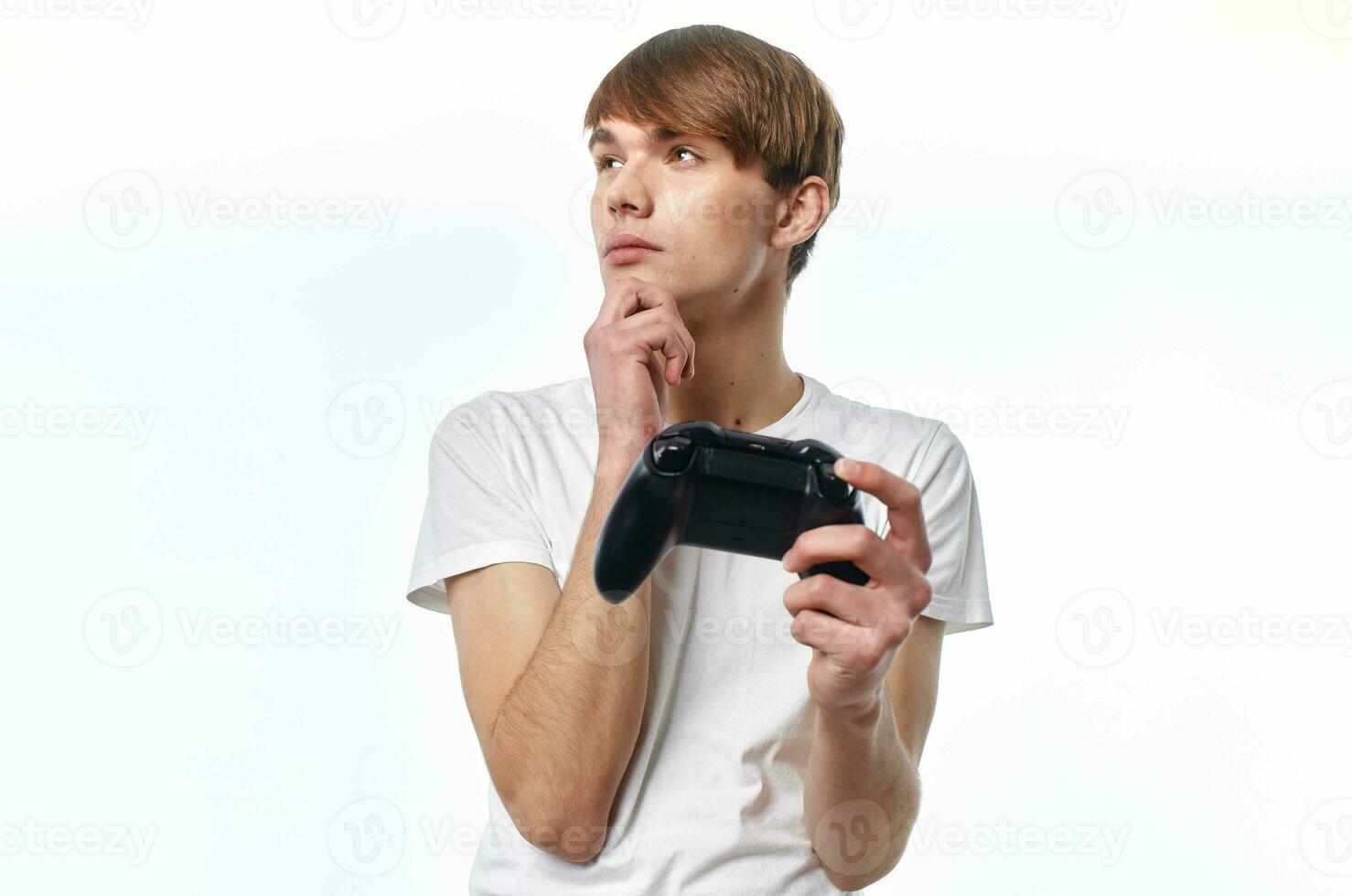 a man in a white t-shirt with a joystick in his hands playing hobby lifestyle photo