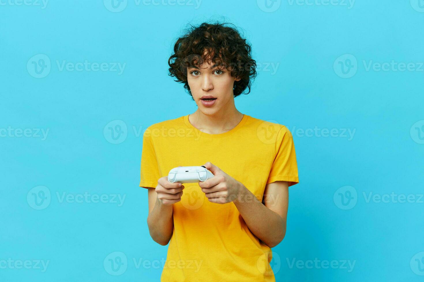 guy yellow T-shirt with joystick video games isolated backgrounds photo
