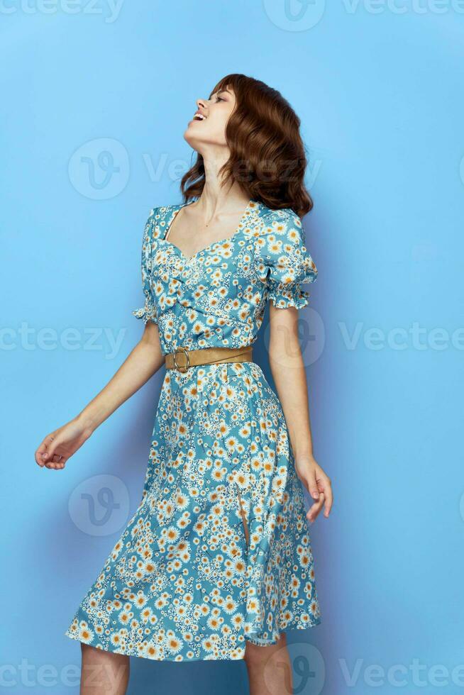 Woman in flower dress Looks up with an open mouth fashionable hairstyle photo