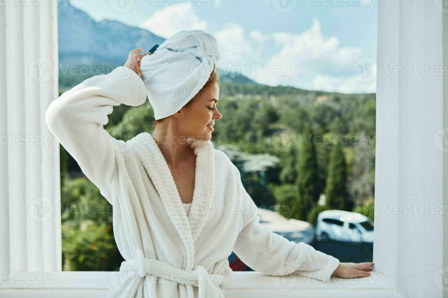 Portrait woman in a white robe on the balcony bit on green nature Lifestyle photo