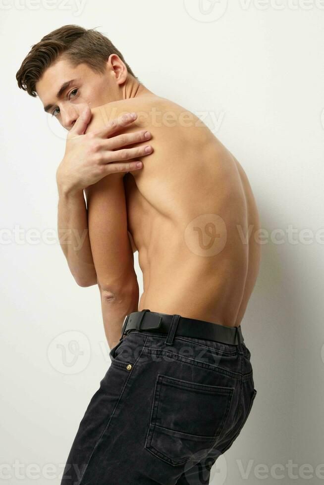 un hombre con un desnudo cuerpo soportes con su espalda posando atractivo tipo de estilo de vida foto