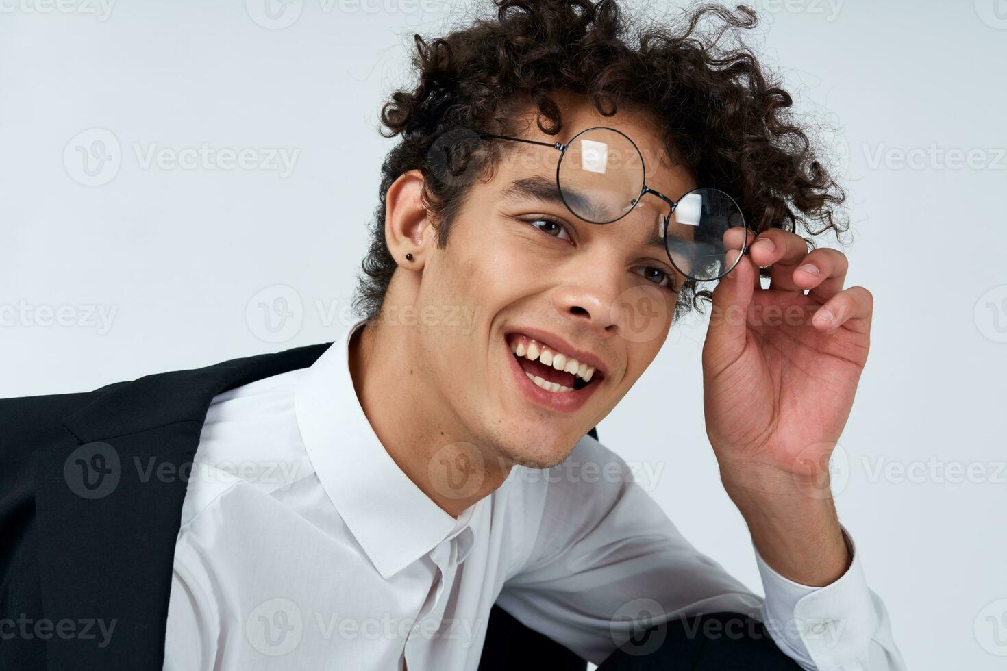 pretty guy in glasses and in a classic suit on a light background portrait close-up fashion style photo